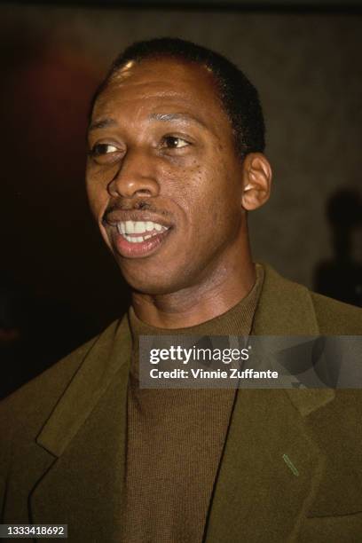 American singer-songwriter Jeffrey Osborne wearing a brown sweater beneath an olive green blazer, location unspecified, circa 1995.