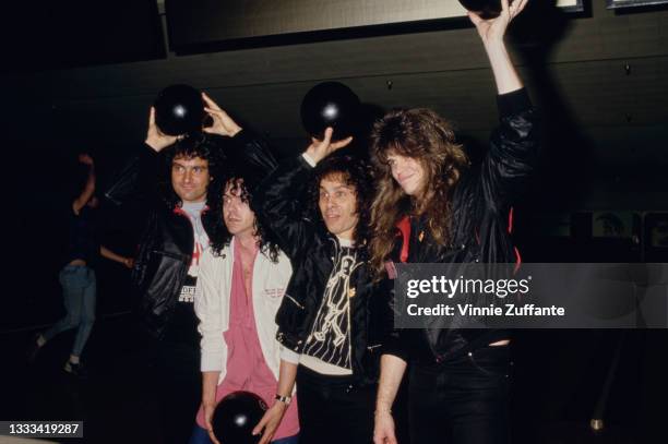 American heavy metal band Dio pose with bowling balls at a bowling fundraiser for the TJ Martell Foundation, venue unspecified, in Los Angeles,...