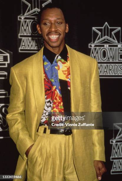American singer-songwriter Jeffrey Osborne, wearing a yellow suit with a multi-coloured shirt, attends the 1st Annual Movie Awards, held at the...