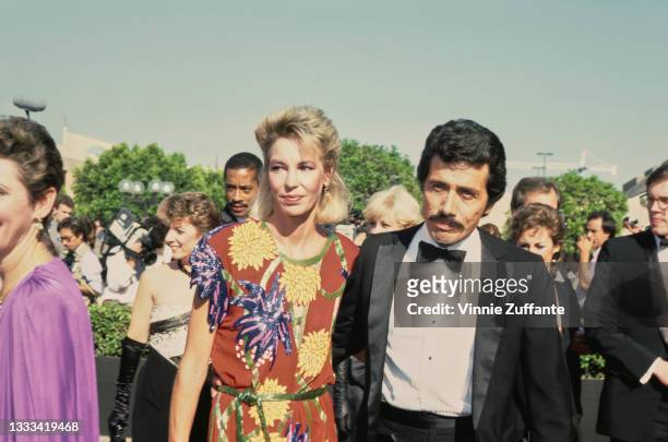 American actor Edward James Olmos and his wife Kaija, wearing a red dress with floral motifs, attend the 37th Annual Primetime Emmy Awards, held at...