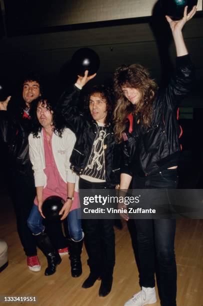 American heavy metal band Dio pose with bowling balls at a bowling fundraiser for the TJ Martell Foundation, venue unspecified, in Los Angeles,...