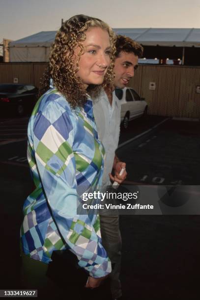 American singer, songwriter and musician Joan Osborne and an unspecified male companion attend the 5th Annual MTV Movie Awards, held at Walt Disney...