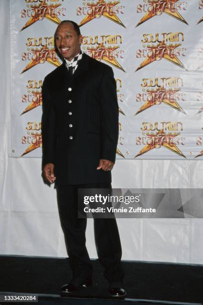 American singer-songwriter Jeffrey Osborne, wearing a black suit with a black-and-white checked shirt, attends the 2nd Annual Soul Train Christmas...