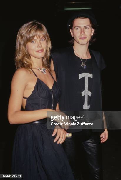Danish fashion model Renee Simonsen, wearing a black dress, and British musician and songwriter John Taylor, wearing a black jacket over a t-shirt...