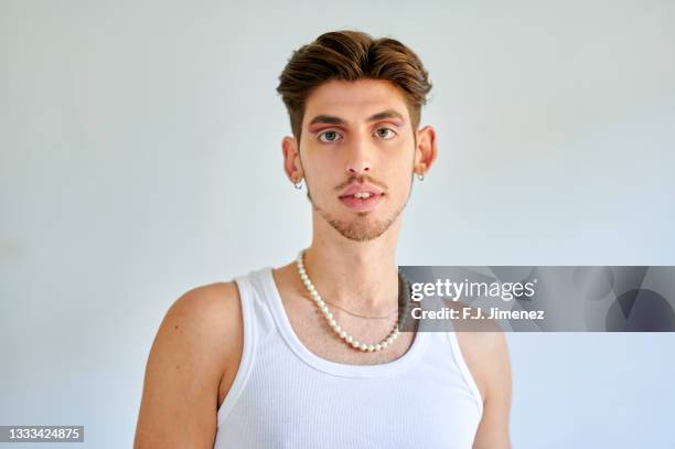 portrait of man with makeup in front of white wall - generation z makeup stock pictures, royalty-free photos & images