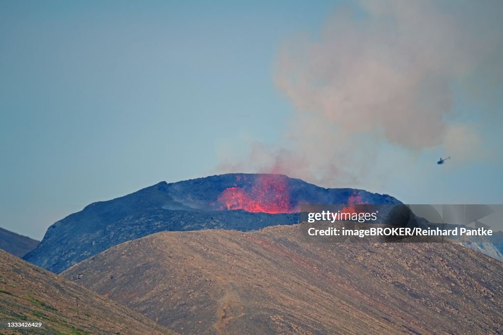 Active volcano with lava fountains, helicopter in front of it, Fagradalsfjall, Geldingadalir, Reykjanes, Sudurnes, Iceland