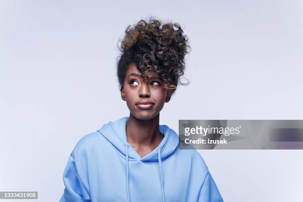 confused young woman in blue hoodie - blå blus bildbanksfoton och bilder