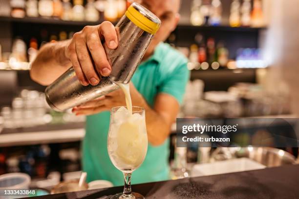 bartender making cocktail on bar counter - barman tequila stock pictures, royalty-free photos & images