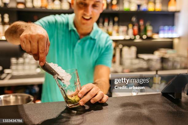 bartender making cocktail on bar counter - barman tequila stock pictures, royalty-free photos & images