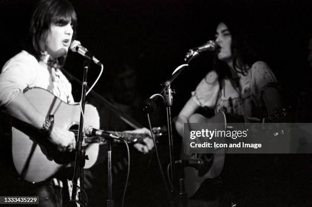 American singer, songwriter, guitarist and pianist Gram Parsons performing with American singer, songwriter, and musician Emmylou Harris during...