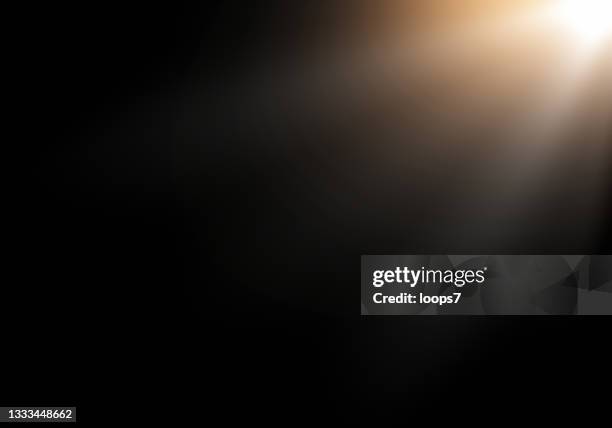 light rays - lens flare black background stock illustrations