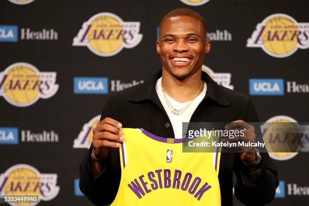 Russell Westbrook of the Los Angeles Lakers poses for a picture with his jersey during a press conference at Staples Center on August 10, 2021 in Los...