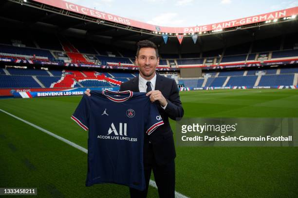Lionel Messi poses with the Paris Saint-Germain jersey after signing a 2 year contract at Parc des Princes on August 10, 2021 in Paris, France.