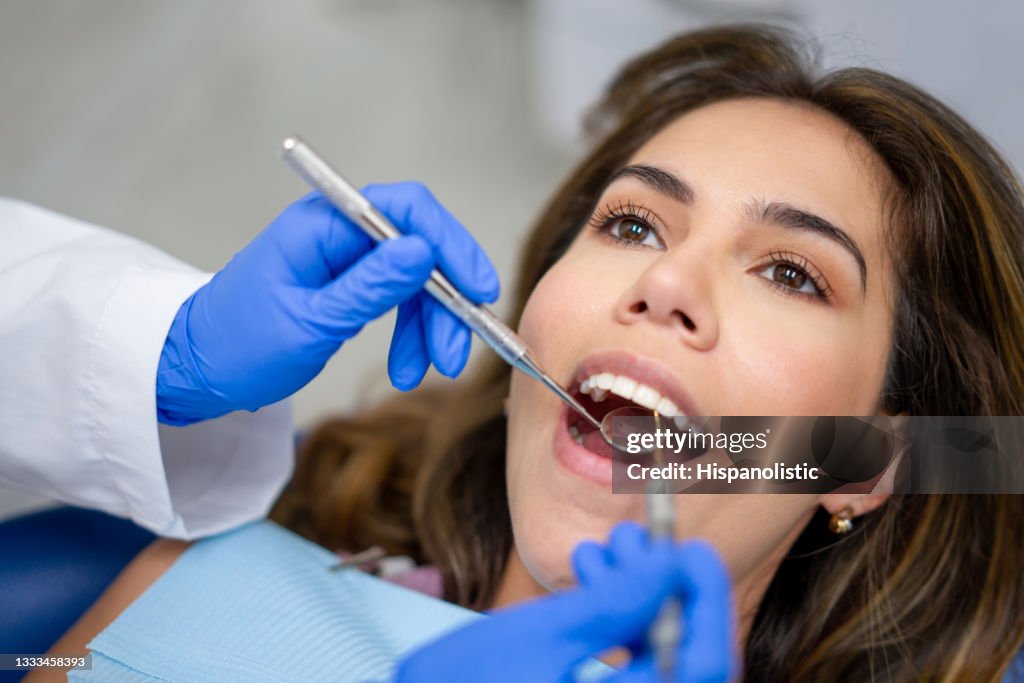Patient at the dentist getting her teeth cleaned