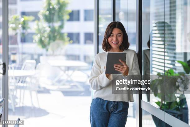 young business woman using a digital tablet. - woman using digital tablet stock pictures, royalty-free photos & images