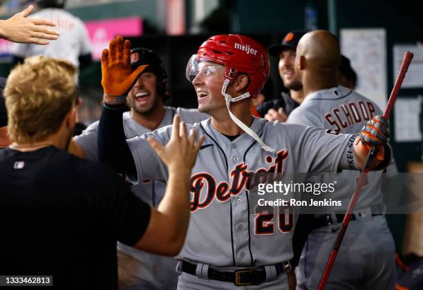 Spencer Torkelson of the Detroit Tigers celebrates with teammates after hitting a three-run home run against the Texas Rangers during the eighth...