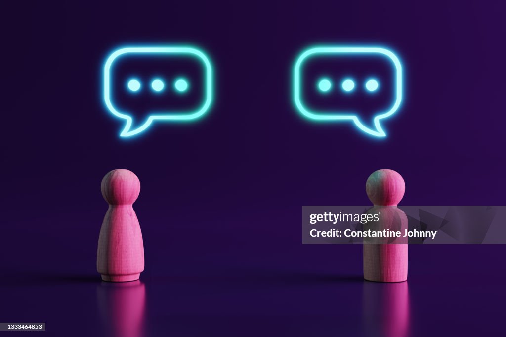 Two Wooden People Figures Communicating