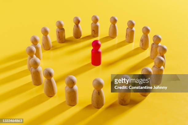circle of wood people figures with leader in the middle. leadership concept with wooden toy. - choosing candidate stock pictures, royalty-free photos & images