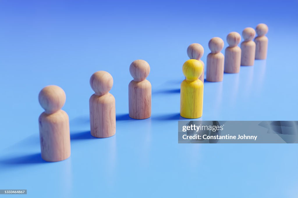 Stepping Out to be Different. Teamwork and Leadership Concepts with Wooden People Figures.