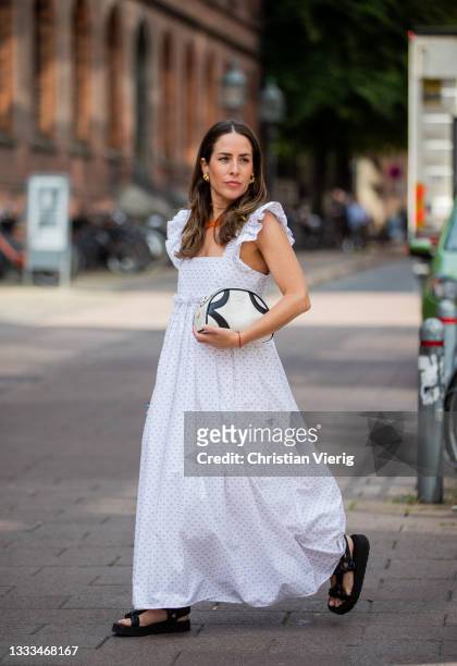 Idalia Salsamendi is seen wearing white Dress: Brøgger, Shoes and purse: Prada on August 10, 2021 in Copenhagen, Denmark.