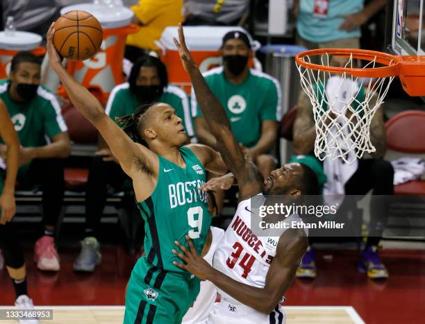 Romeo Langford of the Boston Celtics dunks against Davon Reed of the Denver Nuggets during the 2021 NBA Summer League at the Thomas & Mack Center on...