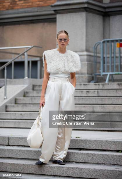 Hilda Sandström seen wearing white vest, creme white pants, bag outside malaikaraiss on August 10, 2021 in Copenhagen, Denmark.