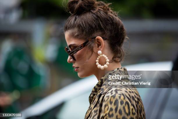 Lele Berlin seen wearing sunglasses, earrings, jacket with animal print outside 7 Days Active on August 10, 2021 in Copenhagen, Denmark.