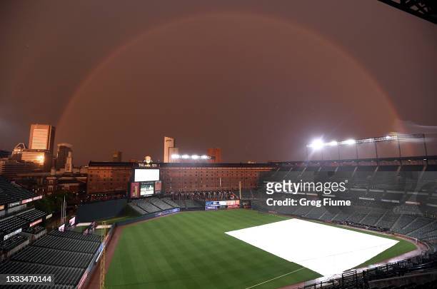 Rainbow spans Oriole Park at Camden Yards during a rain delay of the game between the Baltimore Orioles and the Detroit Tigers on August 10, 2021 in...