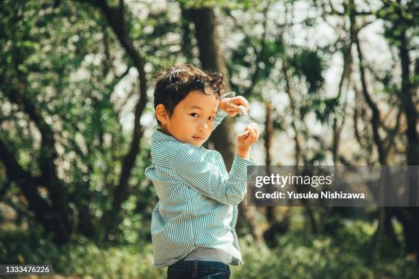 a boy playing outdoors - cute japanese boy stock-fotos und bilder