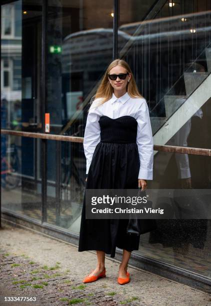 Tine Andrea is seen wearing black dress, white button shirt outside 7 Days Acticon August 10, 2021 in Copenhagen, Denmark.