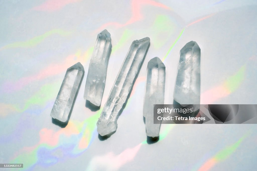 Transparent quartz crystals with rainbow light background