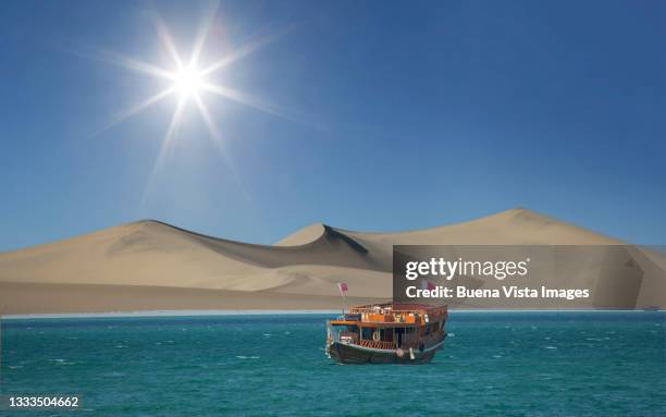 traditional arab boat and sand dune - tradition stock pictures, royalty-free photos & images