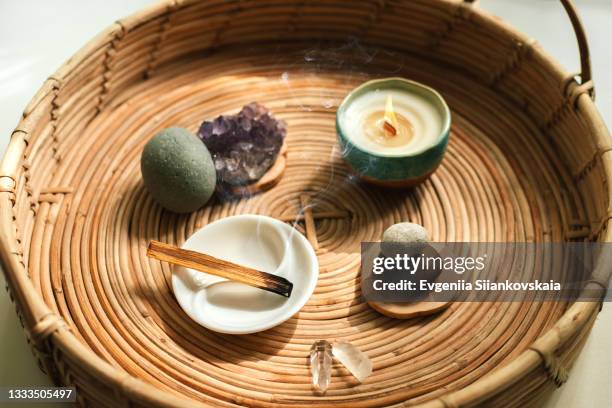 stick of aromatic tree palo santo for meditation with different stones, minerals and candle in a plate. - purezza foto e immagini stock