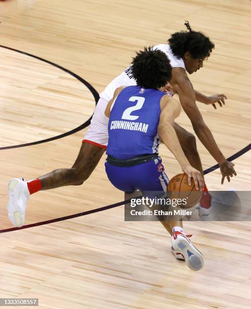 Cade Cunningham of the Detroit Pistons dribbles the ball behind his back to get away from Jalen Green of the Houston Rockets before hitting a...