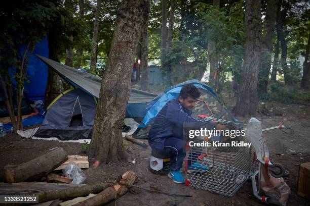 Refugee from Kurdistan eats breakfast in their makeshift camp in the Dunkerque Jungle on July 30, 2021 in Dunkerque, France. Around 2,000 migrants...
