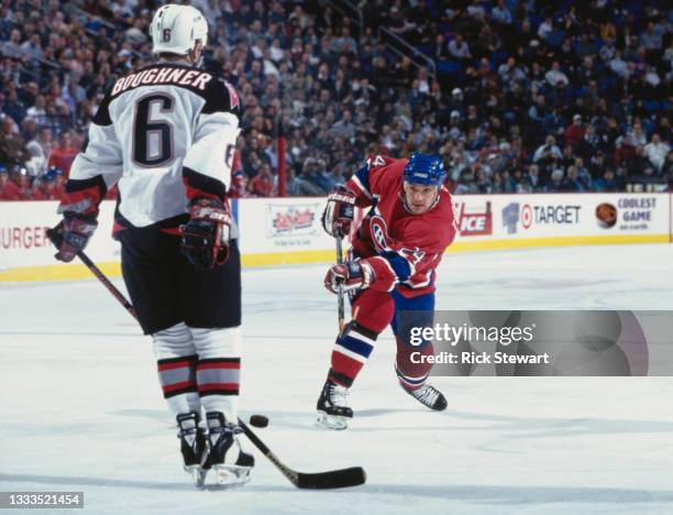 Scott Thornton, Center for the Montreal Canadiens takes a shot on goal through the defending Bob Boughner of the Buffalo Sabres during their NHL...
