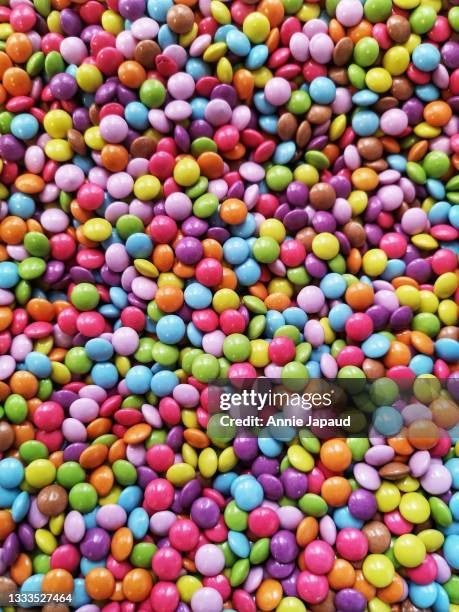 top view and closeup of multicoloured smarties - annie sprinkle stock pictures, royalty-free photos & images