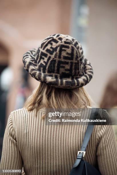 Guest wearing beige knitted jump suit, Fendi bag and brown Fendi hat outside Love Child 1979 during Copenhagen fashion week SS22 on August 10, 2020...