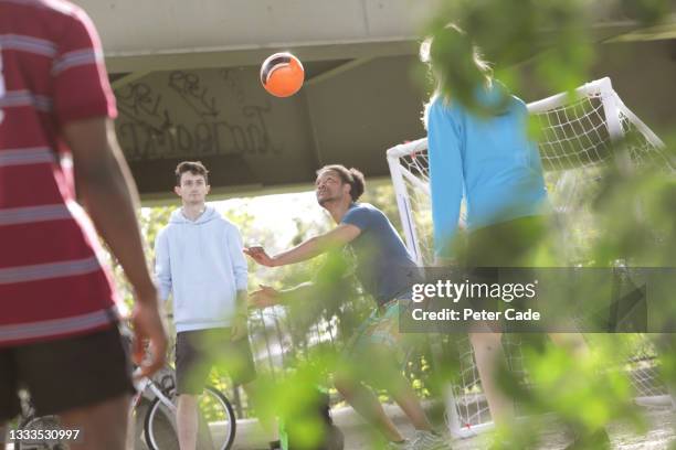 group of friends playing football in city - speed motion lines to the middle stock-fotos und bilder