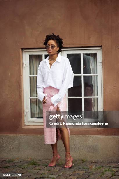 Elizabeth Delphine wearing white shirt and pink skirt with pink mini bag and heart shaped sunglasses outside Love Child 1979 during Copenhagen...