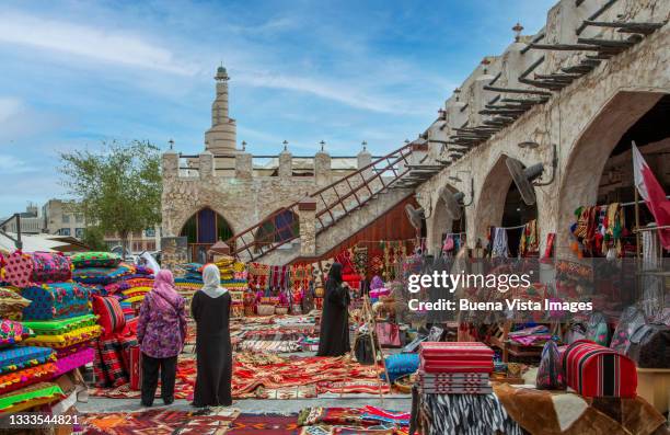 carpets on sale in an oriental souk. - doha street stock pictures, royalty-free photos & images