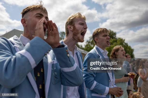 Spectators cheers as boats race on day one of the Henley Royal Regatta on July 11, 2021 in Henley-on-Thames, England. The Henley Royal Regatta is...