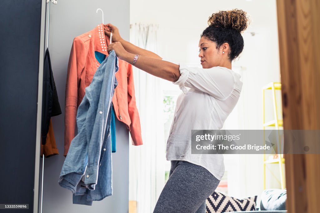 Woman organizing closet at home