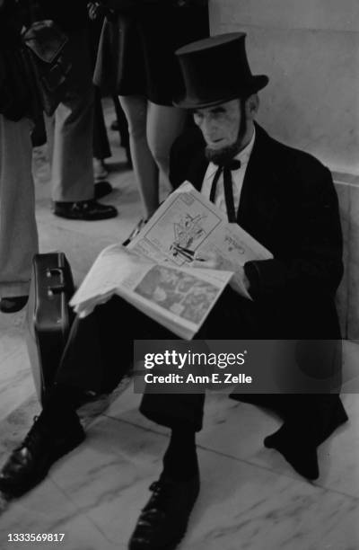 Portrait of American lawyer Arthur L 'Abe' Johnson as he sits, reading a newspaper, on the floor of the Russell Senate Office Building, Washington...