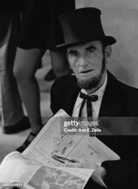 Portrait of American lawyer Arthur L 'Abe' Johnson as he sits, an open newspaper in his hands, on the floor of the Russell Senate Office Building,...