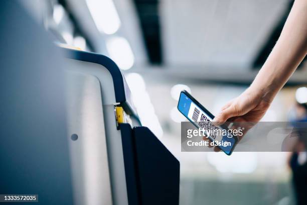 cropped shot of young asian woman scanning qr code, checking in at subway station, making a quick and easy contactless payment for subway ticket via smartphone. nfc technology, tap and go concept - nfc payment stock-fotos und bilder