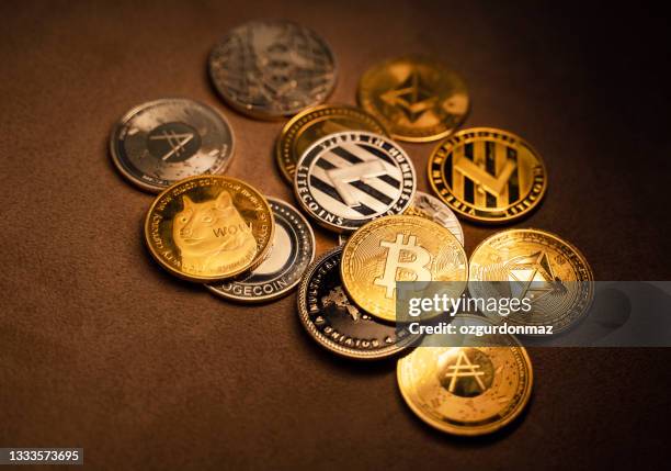 close up shot of bitcoin and alt coins cryptocurrency over brown background - cryptocurrencies stockfoto's en -beelden