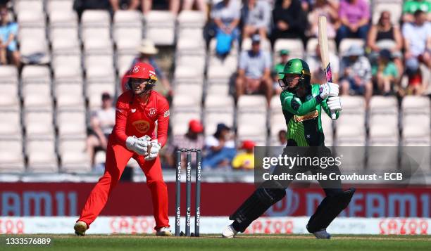 Danni Wyatt of Southern Brave Women plays a shot as Sarah Taylor of Welsh Fire Women looks on during The Hundred match between Southern Brave Women...