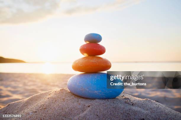 stack of colorful balanced stones at the sea - balance stones stock pictures, royalty-free photos & images
