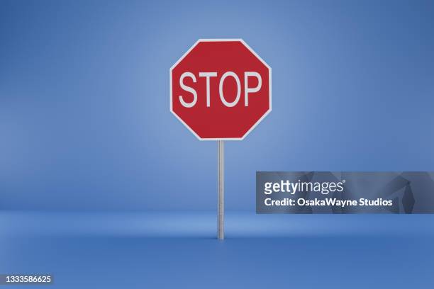 red stop sign against blue background. octagonal road sign. - stop stock pictures, royalty-free photos & images
